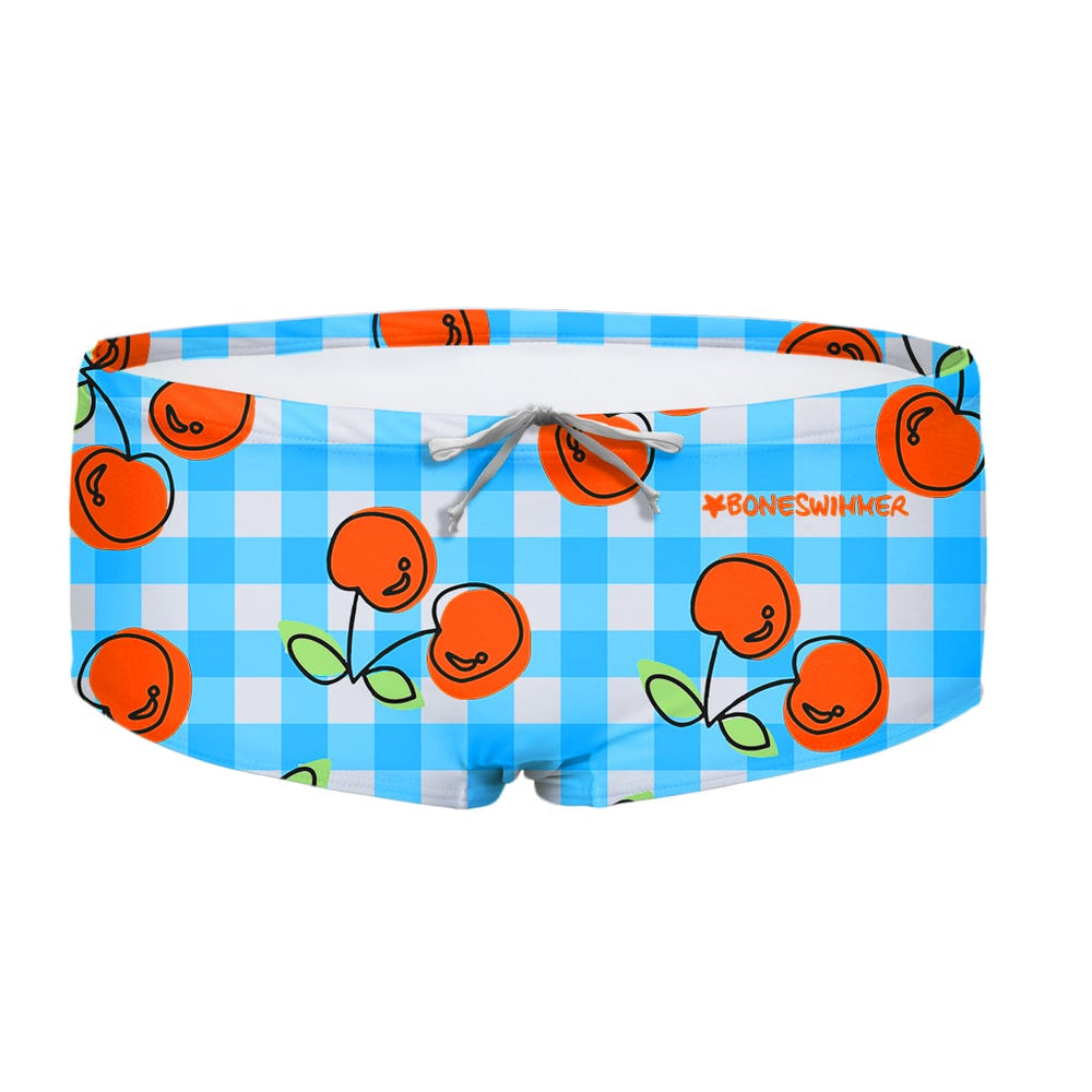 Costume da allenamento nuoto in piscina Boneswimmer da uomo, modello parigamba UCLA 211UF VICHY CILIEGIE con illustrazione a pattern di quadretti bianchi e azzurri con ciliegie rosse e dettagli verdi; fronte